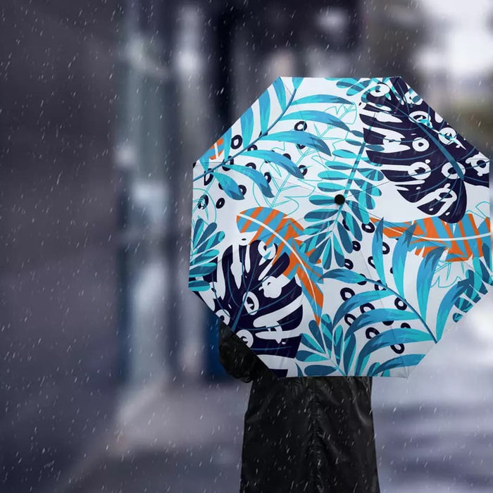 Full Colour Poppins Umbrella - A full colour umbrella featuring a vibrant tropical leaf pattern in shades of blue, white, orange, and green.