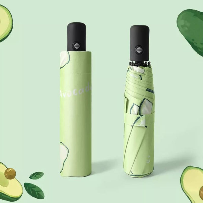 Full Colour Poppins Umbrella - A green umbrella featuring an avocado design, neatly folded and compact. It includes a handle and has branding.