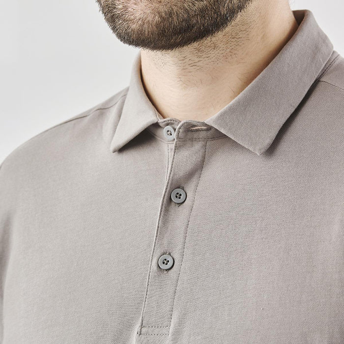 Men's Nevada L/S Micro Pique Polo - A men's long-sleeve polo shirt in a muted grey shade featuring a collar and button details. It includes a logo on the chest.