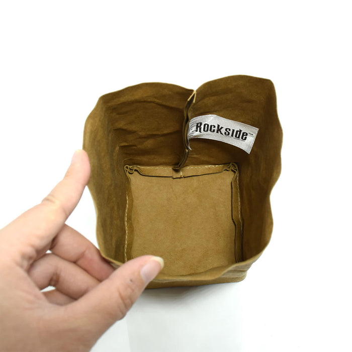 Sewo Kraft Paper Storage Bag – Small - A small brown kraft paper storage bag with a decorative tag inside, being held by a hand.