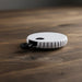 Yes or No Game Set Bottle Opener - A drink bottle opener in white with a textured grip, resting on a wooden surface. It features a logo.