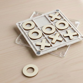 Tic Tac Toe Board Game Coaster - A Tic Tac Toe board game coaster with a clear base, featuring wooden X and O pieces in a grid pattern.