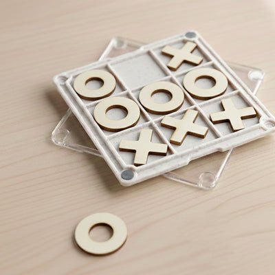 Tic Tac Toe Board Game Coaster - A Tic Tac Toe board game coaster with a clear base, featuring wooden X and O pieces in a grid pattern.