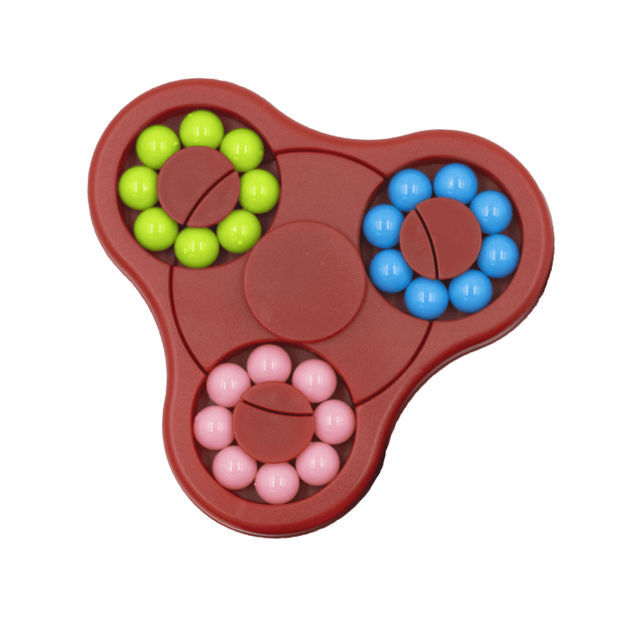 The Spin Buddy Puzzle Game - A red puzzle game with three sections, featuring pink, green, and blue balls arranged in circular patterns.