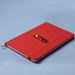 Space A5 Notebook - A red A5 notebook with an elastic band and a branding logo on the cover.