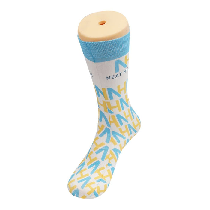 Magic Dress Socks - A pair of socks featuring a blue and white design with a pattern in yellow, displayed on a sock mannequin.