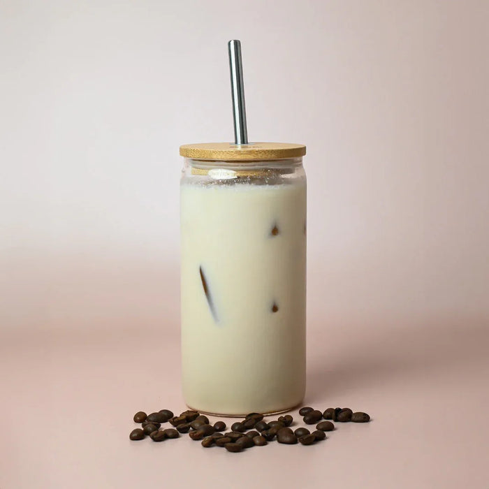 Carnaby 500ml Tumbler - A drink bottle with a bamboo lid and stainless steel straw, filled with a creamy iced beverage and surrounded by coffee beans.