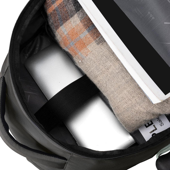 Swissdigital Vector Backpack - A green backpack interior features a laptop, a blanket, and documents, all nestled inside.