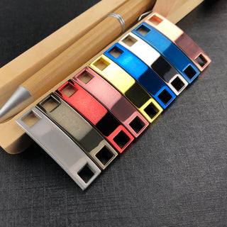 Luxury Shoelace Charms - A collection of colourful luxury shoelace charms displayed alongside a pen on a textured surface.