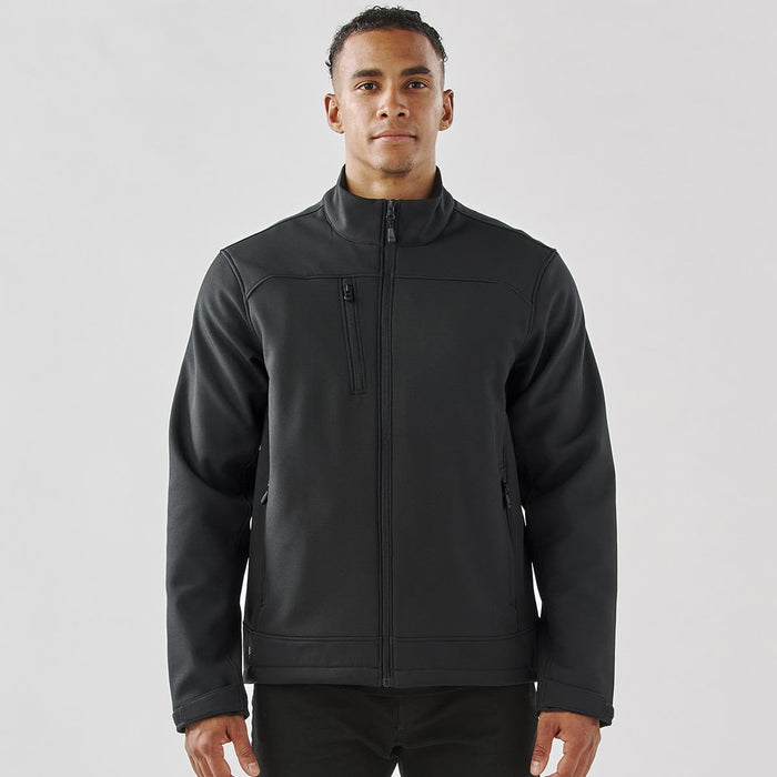 Men's Aleutian Softshell Jacket - A men's softshell jacket in black, featuring a front zip and a branded logo on the chest.