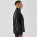 Men's Aleutian Softshell Jacket - A side view of a men's black softshell jacket featuring a zip closure and pockets, with a logo on the chest.