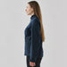 Women's Aleutian Softshell Jacket - A softshell jacket in navy blue, featuring a zip pocket, shown from the side on a model with long hair.