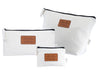 Calico Travel Set - A set of three white fabric bags with black zippers and a branded leather patch.