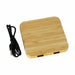 Trafalgar Bamboo charging dock - A bamboo wireless charging dock with two USB ports and a black charging cable.