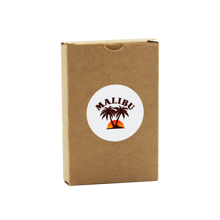 Eco Playing Cards - A brown cardboard box containing eco-friendly playing cards, featuring a logo with palm trees and a sunset design.