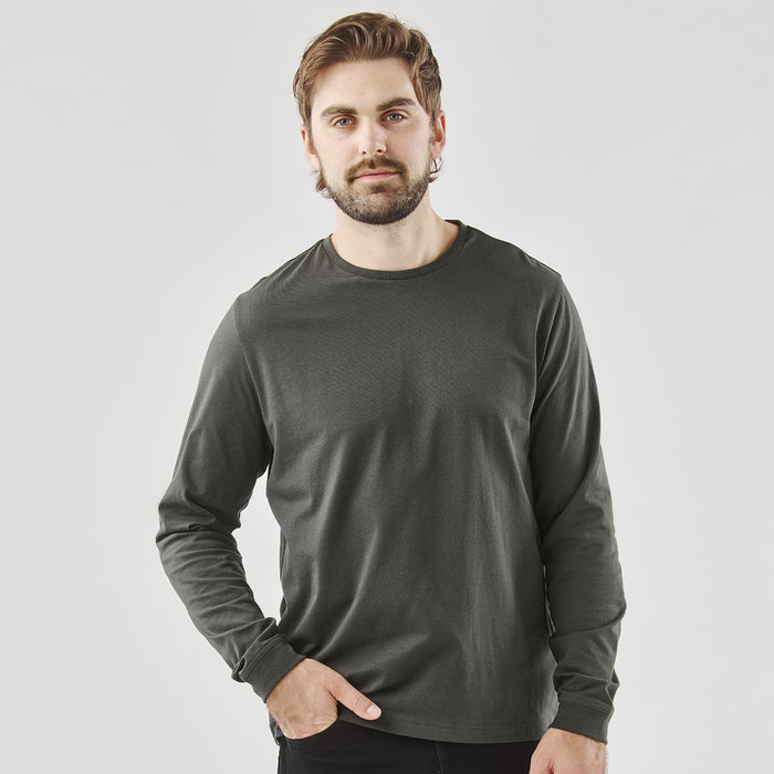Men's Settebello L/S Tee - A man poses in a long-sleeve tee in dark green, paired with black pants, featuring a logo on the shirt.