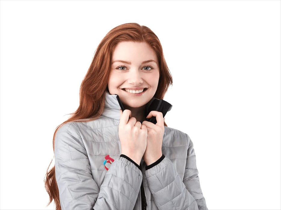 Womens Telluride Lightweight Packable Insulated Puffer Jacket - A woman wearing a grey lightweight insulated puffer jacket with a logo, smiling and adjusting the collar.