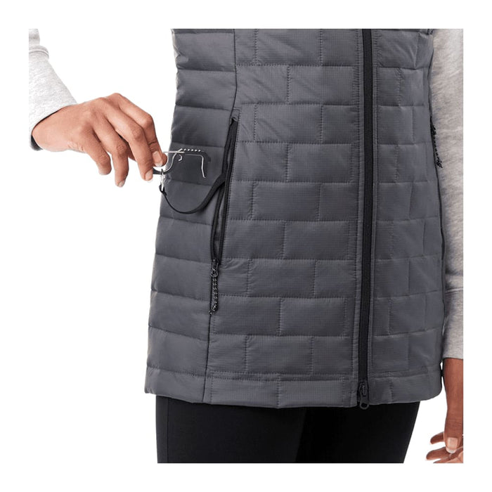 Women's Telluride Lightweight Packable Insulated Puffer Vest - A dark grey lightweight packable insulated puffer vest with a zippered pocket, featuring a hand placing glasses inside.