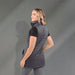 Women's Telluride Lightweight Packable Insulated Puffer Vest - A woman wearing a grey lightweight packable insulated puffer vest, showcasing a side view with a smooth background.