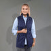 Women's Telluride Lightweight Packable Insulated Puffer Vest - A navy insulated puffer vest with a zip front and side pockets, worn over a light blue shirt.