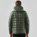 Men's Tundra Thermal Jacket - A men's puffer jacket in a muted green colour, featuring a hood and a quilted pattern on the back.