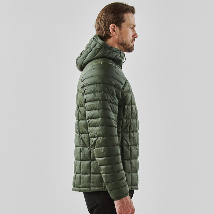 Men's Tundra Thermal Jacket - A olive green puffer jacket with a hood, featuring a quilted design. It has a logo on the garment.