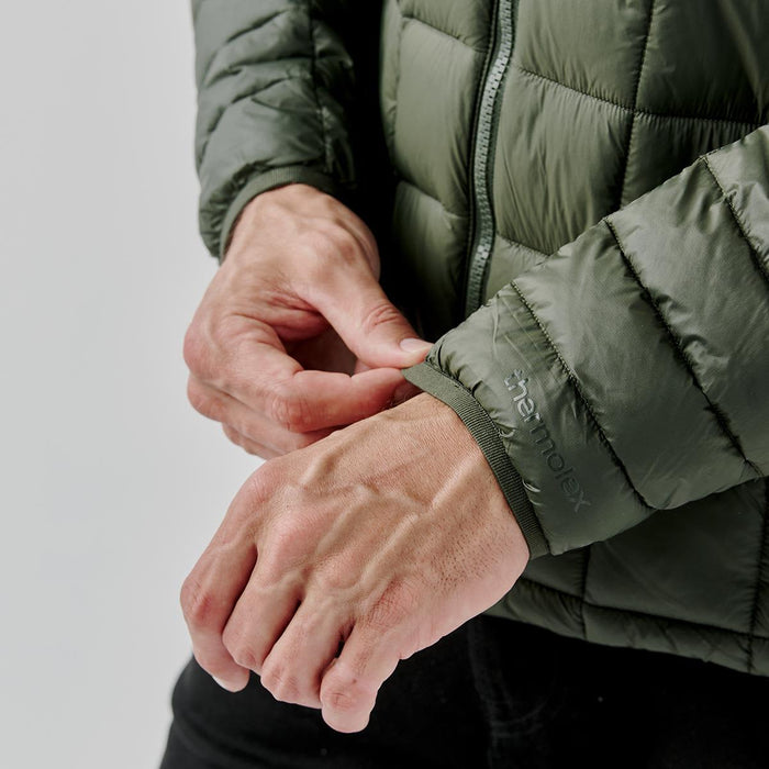 Men's Tundra Thermal Jacket - A Men's Tundra Thermal Jacket in olive green, featuring a puffer style and a close-up of the cuff detail.