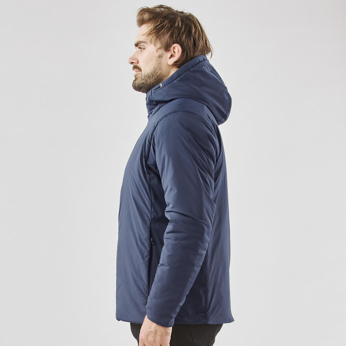 Men's Cascadia Thermal Jacket - A men's thermal puffer jacket in navy, featuring a hood and a branded logo, displayed on a model in profile.
