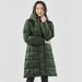 Women's Elkridge Parka - A long, green puffer jacket featuring a hood and a quilted design, presented on a model.
