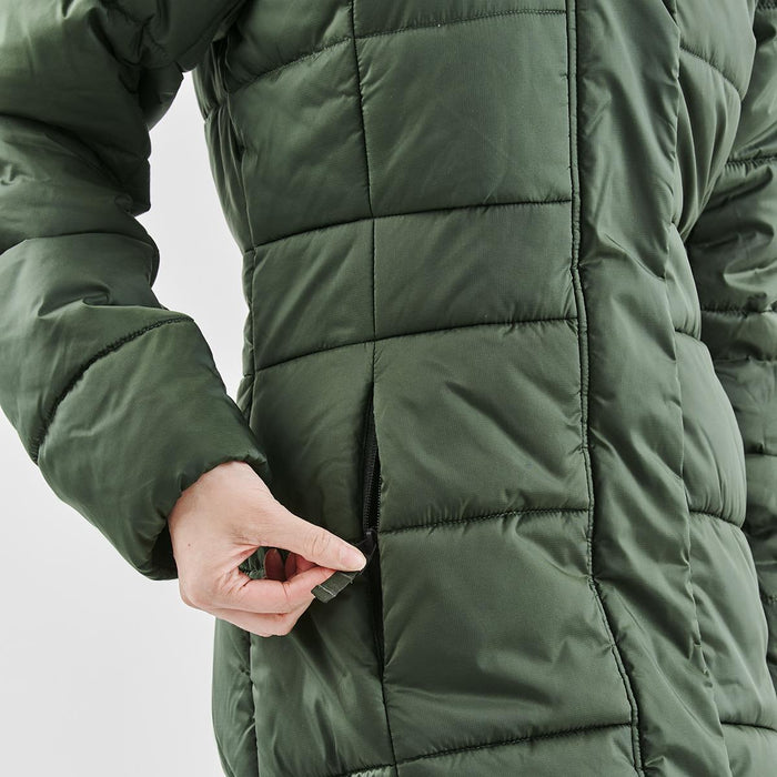 Women's Elkridge Parka - A green women's puffer jacket with a zipper pocket and quilted texture, featuring a person’s hand interacting with it.
