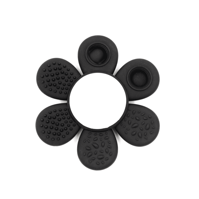 The Spinzy - A black silicone product shaped like a flower with various textured petal designs and a central circular opening.