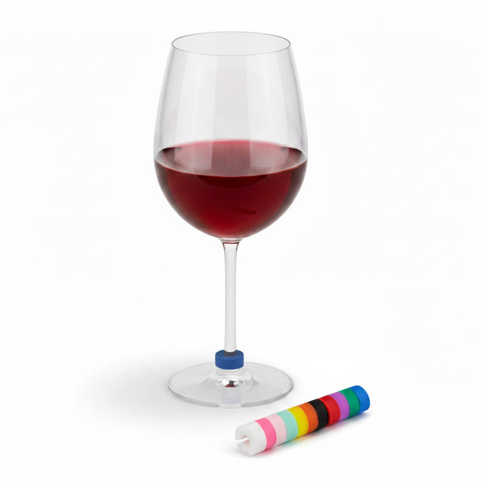 Wine Glass Marker - A red wine glass with a blue wine glass marker beside a roll of colourful markers. The glass is elegantly shaped.