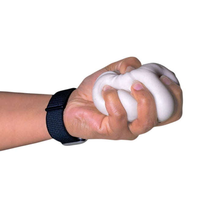 Squishy Bun - A hand gripping a white squishy stress toy, with a black wristwatch visible on the wrist.