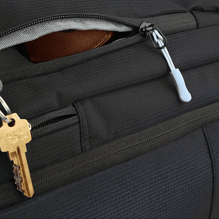 Wander & Roam Travel Backpack - A close-up of a black backpack, featuring zippers and a keychain with a key attached.