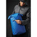 Cirrus Backpack - A blue backpack with a zippered pocket being held by a person in a black jacket and cap. Features a logo.
